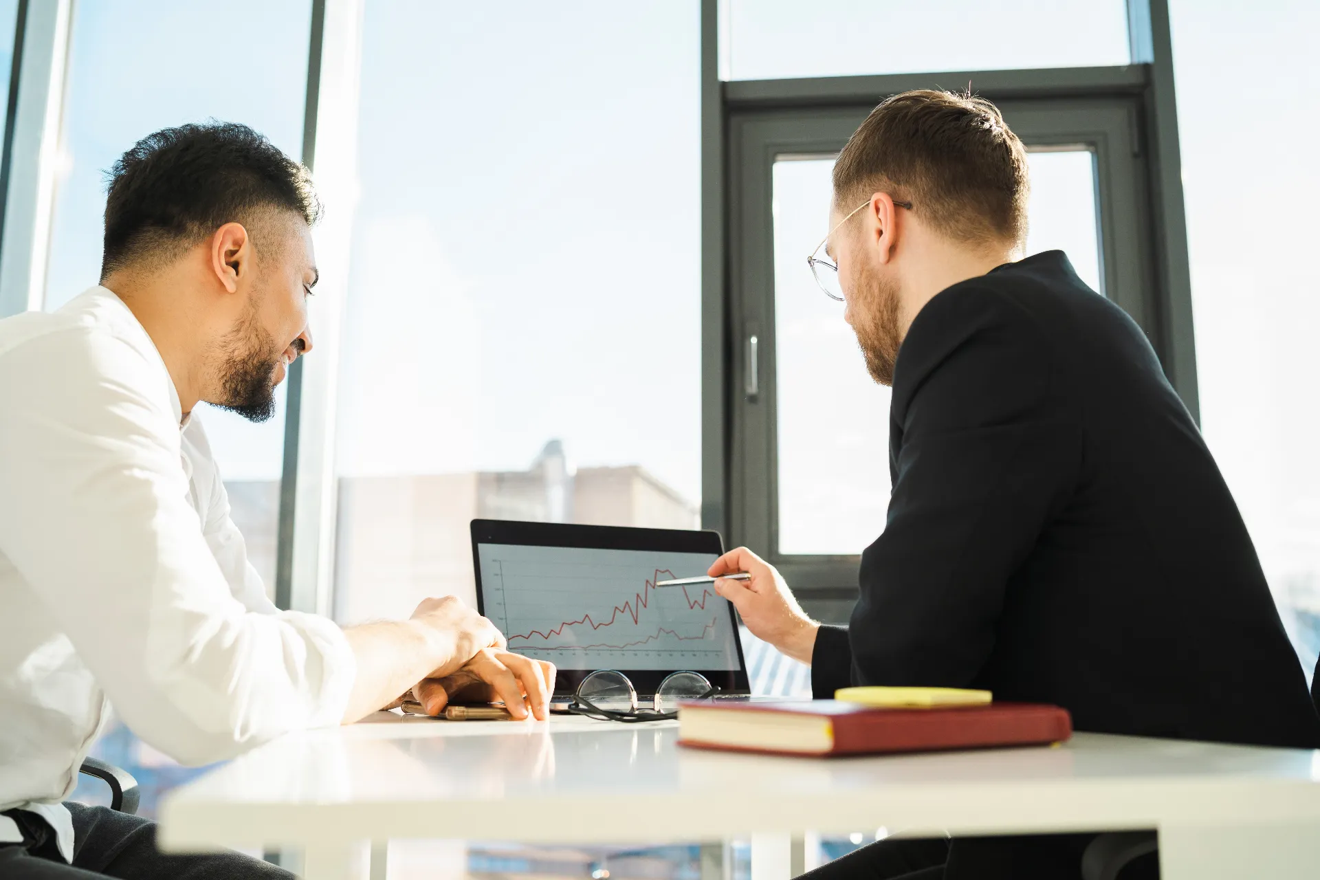 financial advisor reviewing investment portfolio with client
